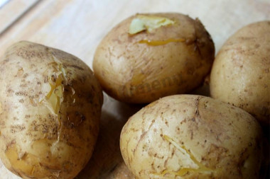 Potatoes with salt in a uniform in microwave oven