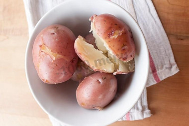 Potatoes with salt in a uniform in microwave oven