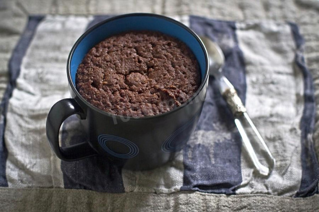 Cupcake in a mug in vegetable oil with cocoa