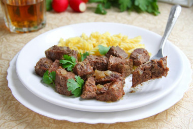 Beef stew in a slow cooker with onions