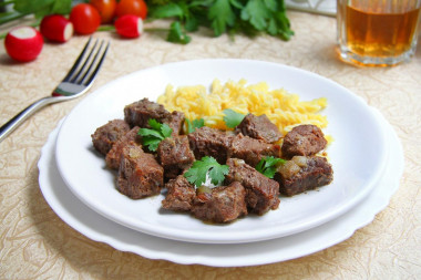 Beef stew in a slow cooker with onions