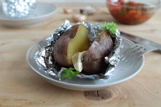 Baked potatoes in a slow cooker in foil in a uniform