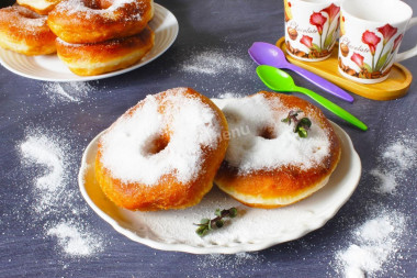 Homemade doughnuts in a pan with yeast