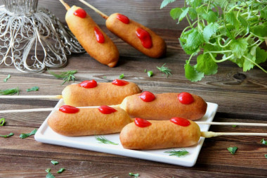 Sausages in liquid corn dough on a stick fried in oil