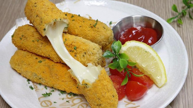 Snack sticks with cheese in milk breading with parsley