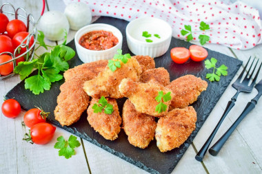 Crispy breaded chicken wings in a frying pan