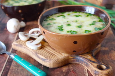 Creamy soup with mushrooms and melted cheese