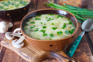 Creamy soup with mushrooms and melted cheese