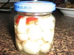 Garlic pickled with chili pepper