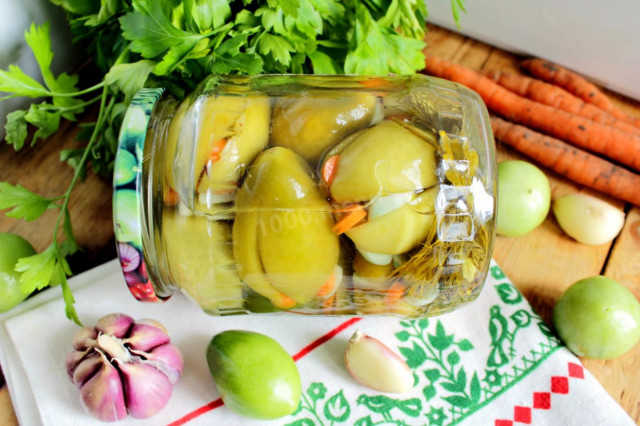 Pickled green tomatoes stuffed with garlic for winter