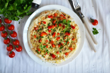 Breakfast of pita bread in a frying pan with egg and cheese filling