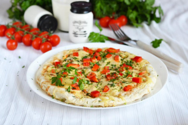 Breakfast of pita bread in a frying pan with egg and cheese filling