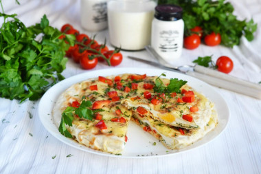 Breakfast of pita bread in a frying pan with egg and cheese filling