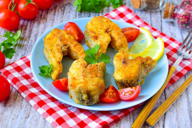 Pollock fried in flour in a frying pan