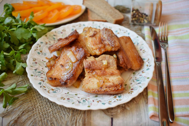 Fried bacon in a frying pan