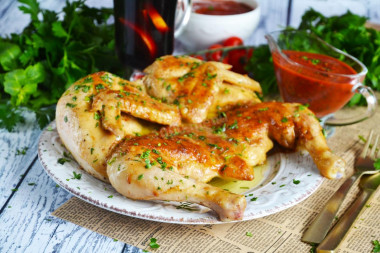 Tobacco chicken in a frying pan with a crispy crust