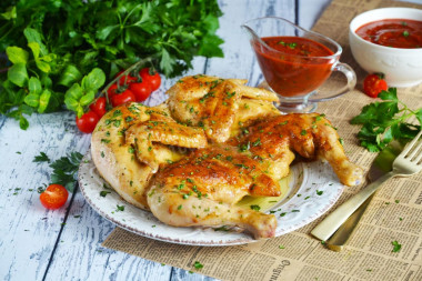 Tobacco chicken in a frying pan with a crispy crust