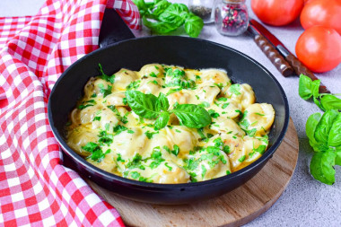 Fried dumplings with cheese in a frying pan