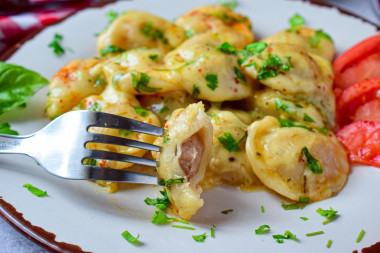 Fried dumplings with cheese in a frying pan