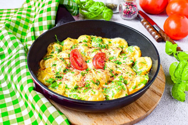 Fried dumplings with cheese in a frying pan