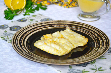 Fried cod fillet in a frying pan