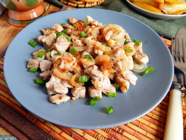 Fried meat with onions in a frying pan