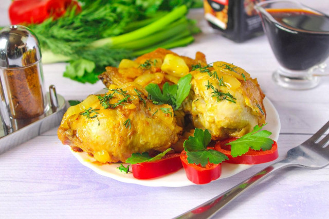 Fried chicken with onions in a frying pan