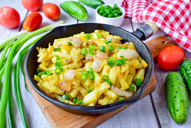 Fried potatoes with bacon and onions in a frying pan