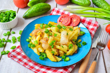 Fried potatoes with bacon and onions in a frying pan