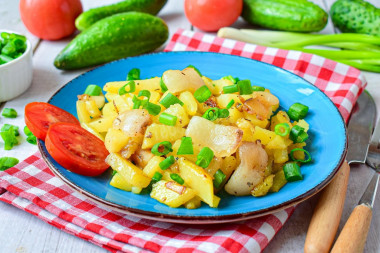 Fried potatoes with bacon and onions in a frying pan