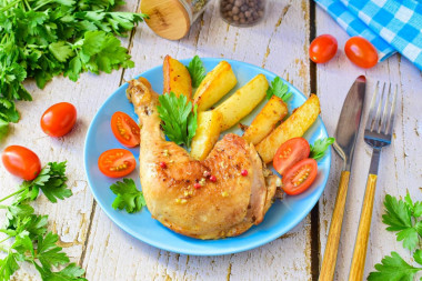 Fried chicken legs in a pan with garlic