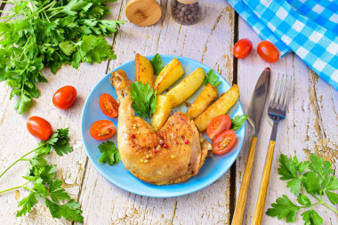 Fried chicken legs in a pan with garlic