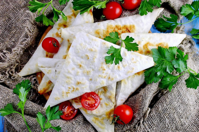 Lazy pita bread chebureks with minced meat in a frying pan