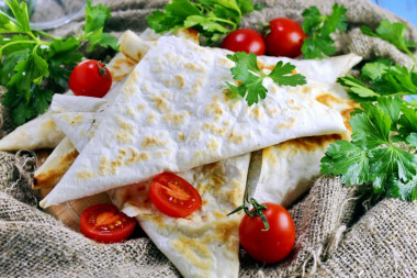 Lazy pita bread chebureks with minced meat in a frying pan