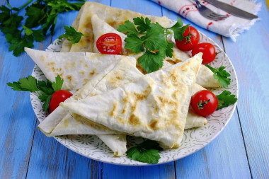 Lazy pita bread chebureks with minced meat in a frying pan