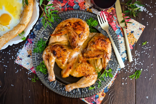 Fried chicken with a golden crust in a frying pan