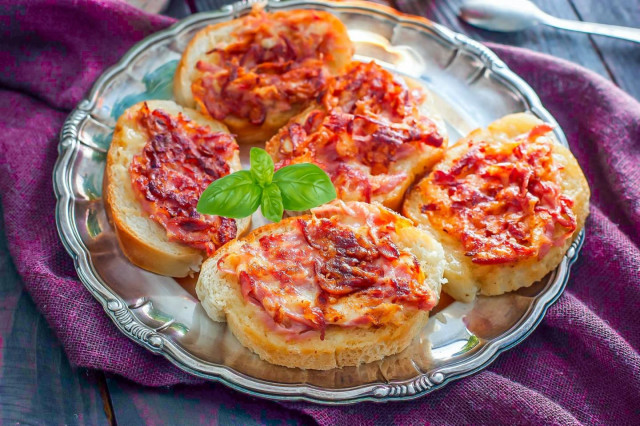 Fried sandwiches with egg sausage and cheese in a pan