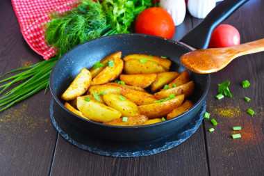 Rustic fried potatoes in a frying pan