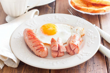 Fried sausages in a frying pan