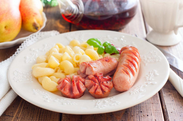 Fried sausages in a frying pan