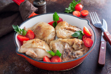 Fried chicken thighs in a frying pan