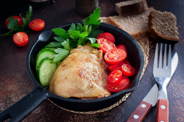 Fried chicken thighs in a frying pan