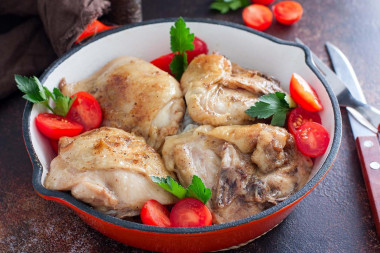 Fried chicken thighs in a frying pan