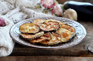 Fried eggplant in batter in a frying pan