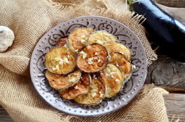 Fried eggplant in batter in a frying pan