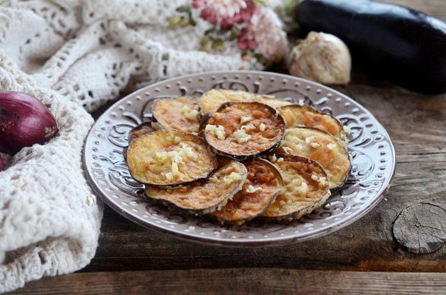 Fried eggplant in batter in a frying pan