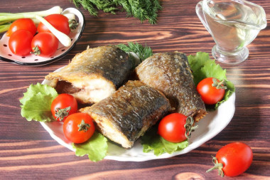 Fried herring in a frying pan