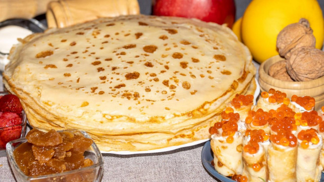 Pancakes with milk with cream cheese and red caviar