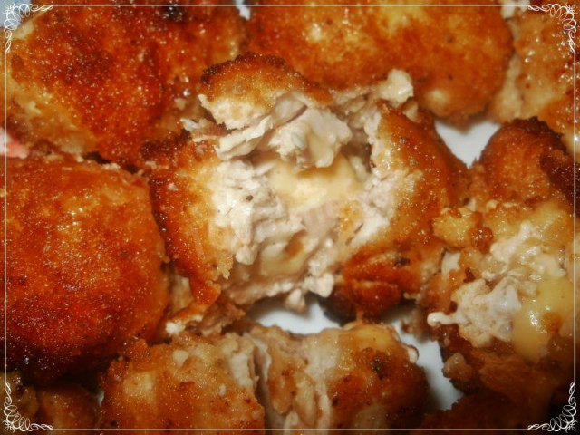 Chicken nuggets with parmesan and garlic in a frying pan