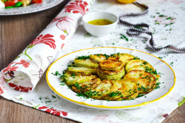 Zucchini in flour in a frying pan